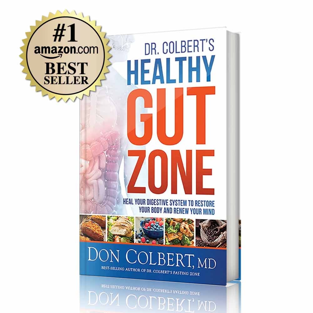 Hardcover book Dr. Colbert’s Healthy Gut Zone by Dr. Don Colbert, MD from Divine Health featuring a cover with digestive system imagery and nutrient-dense foods that represent gut health and microbiome support. This health and nutrition book focuses on restoring digestive balance and strengthening the gut microbiome through nutrition and lifestyle strategies. The guide explains how probiotics help support beneficial gut bacteria, how fiber supplements improve digestion and gut function, and how nutritional approaches that may include collagen powder and MCT oil powder can help promote digestive wellness, metabolic health, and overall vitality through the Divine Health wellness philosophy.
