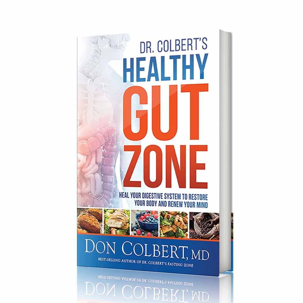 Softcover book Dr. Colbert’s Healthy Gut Zone by Dr. Don Colbert, MD from Divine Health featuring a cover with digestive system imagery and nutrient-rich foods that represent gut health and microbiome balance. This health and nutrition guide focuses on restoring digestive wellness through diet and lifestyle strategies. The book explains how probiotics support beneficial gut bacteria, how fiber supplements help maintain healthy digestion and microbiome diversity, and how nutrition approaches that may include collagen powder and MCT oil powder can support digestive function, metabolic health, and overall wellness through the Divine Health lifestyle approach.