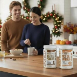 Keto Zone Gingerbread and Pumpkin Spice MCT Oil Powder by Dr. Colbert on kitchen counter with holiday décor in background
