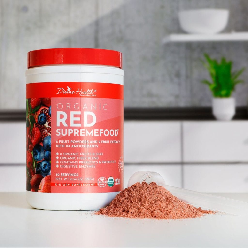 Open container of Organic Red Supremefood by Dr. Don Colbert, MD with scoop and powder on counter, organic antioxidant superfood powder with fruits, probiotics, and digestive enzymes.