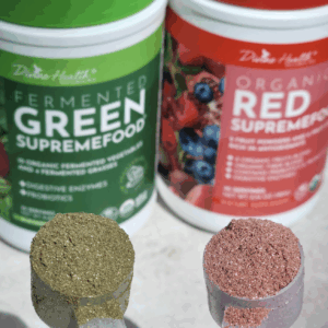 Green Supremefood and Red Supremefood powders by Divine Health with scoops of green and red superfood blends in front of the containers.