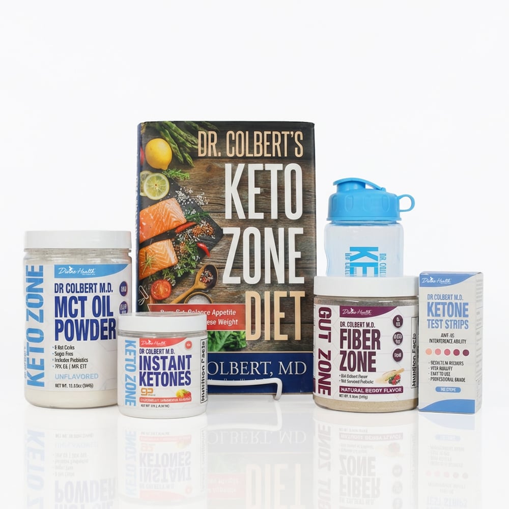 A Keto Zone Starter Pack displayed on a white background, featuring Dr. Colbert’s Keto Zone Diet book standing in the center. In front and beside the book are several Keto Zone products, including MCT Oil Powder in a white jar, Instant Ketones powder in a small container, Fiber Zone Gut Health powder in a larger jar, a box of Ketone Test Strips, and a blue Keto Zone shaker bottle. All items are arranged neatly with clear labels and Divine Health branding by Dr. Don Colbert, MD.