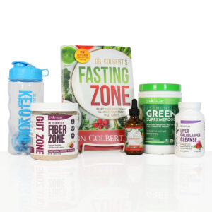 A Divine Health wellness bundle is arranged on a white background. On the far left is a clear Keto Zone shaker bottle with a blue lid and blue vertical lettering. In front of it sits a white container of Dr. Colbert M.D. Gut Zone Fiber with a berry-colored label. Centered in the back is the book Dr. Colbert’s Fasting Zone displayed upright on a white stand. In front of the book is a small amber glass dropper bottle labeled Nano Glutathione. To the right is a large white canister with a green lid labeled Fermented Green Supremefood, and on the far right is a white bottle labeled Dr. Colbert M.D. Liver Gallbladder Cleanse. All items are upright, evenly spaced, and photographed straight on with soft studio lighting.