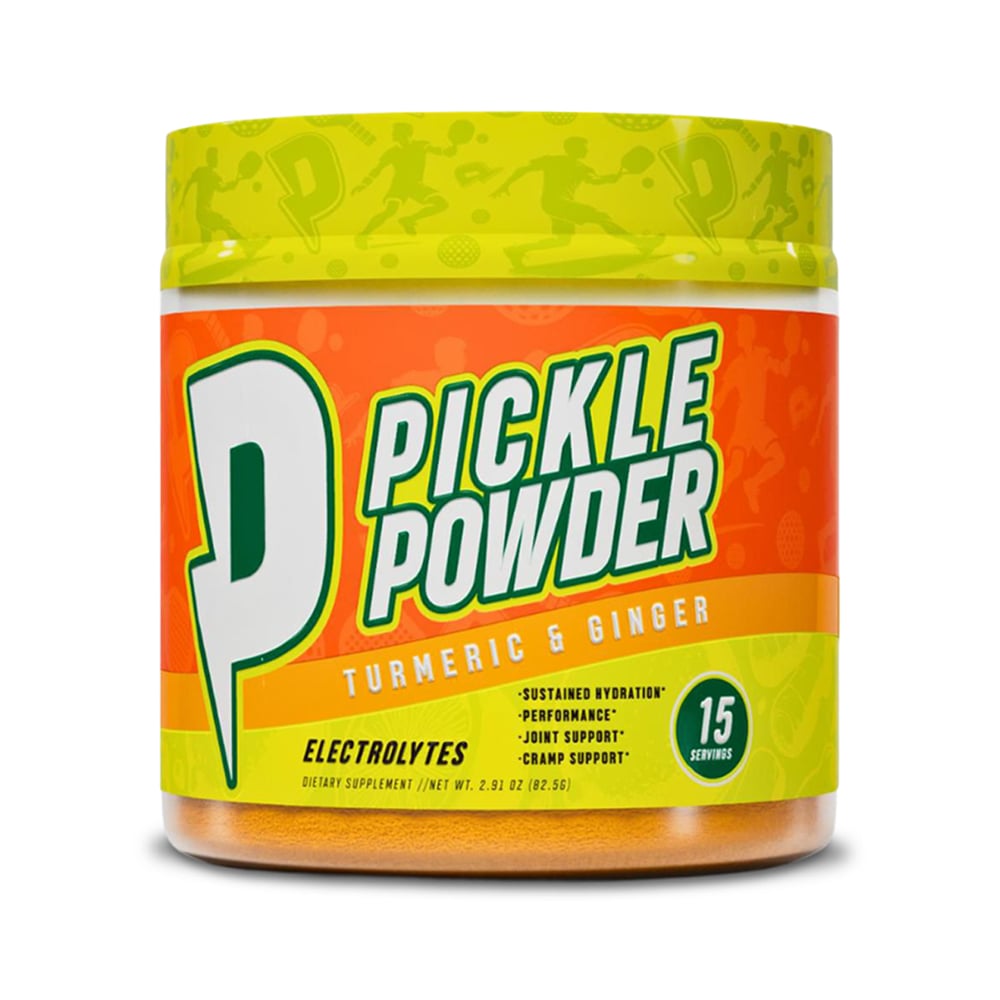 A single container of Dr. Colbert M.D. Pickle Powder is centered against a clean white background. The jar has a bright green lid with a repeating sports-style graphic pattern and an orange label wrapped around the container. The front label features large bold text reading “Pickle Powder” with a prominent green letter “P,” along with “Turmeric & Ginger” and “Electrolytes” printed below. Additional label details include a circular icon noting “15 servings” and smaller text elements arranged in horizontal bands. The container is photographed straight on with even lighting, clearly showing branding, colors, and label design in a studio-style product image.
