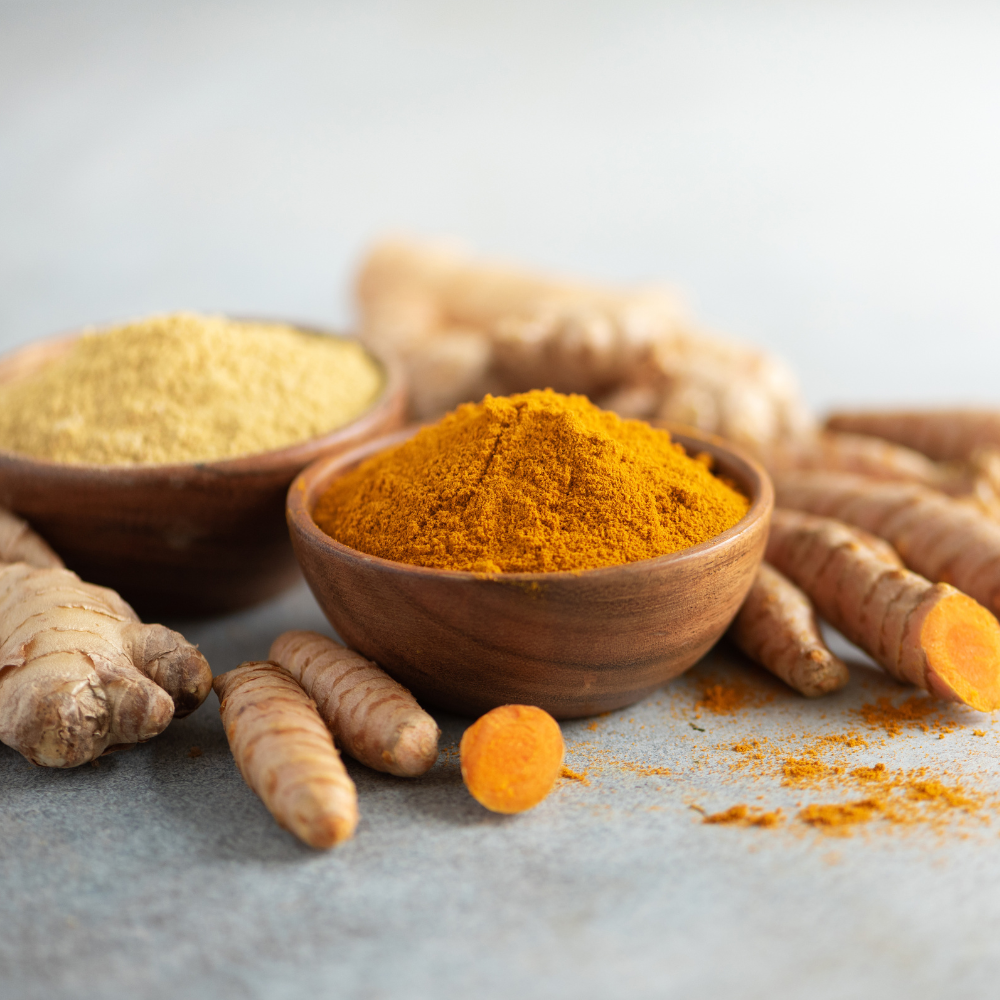 Turmeric and ginger powder with roots used in Pickle Powder supplement for joint health and cramp relief