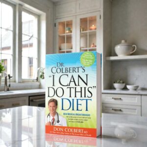 I Can Do This Diet by Dr. Don Colbert, MD from Divine Health displayed upright on a bright kitchen countertop with a modern kitchen background. The weight-loss and nutrition guide focuses on helping readers improve metabolic health and achieve sustainable weight management through smarter food choices. The book discusses how gut health, probiotics, fiber-rich foods, and balanced nutrition can support digestion and energy levels. It also highlights how collagen-supporting proteins and ketogenic-style fats such as MCT oil powder may help support metabolism, appetite control, and overall wellness.