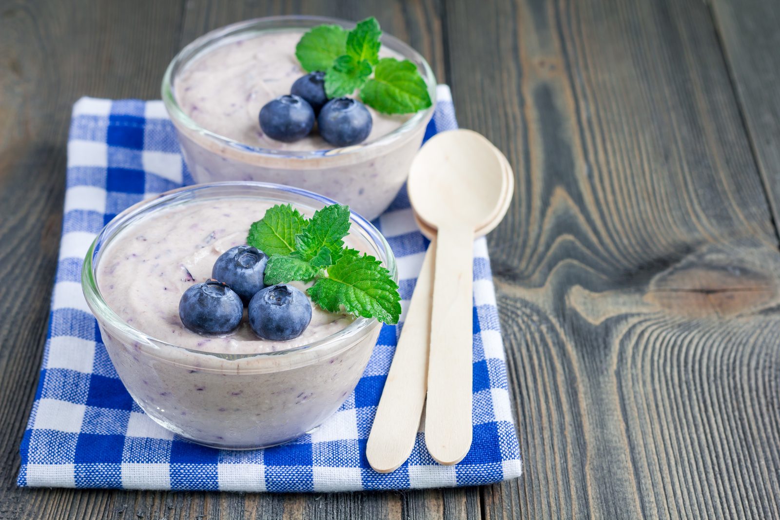 Keto blueberry mousse in glass bowls topped with fresh blueberries and mint, a sugar free low carb keto dessert