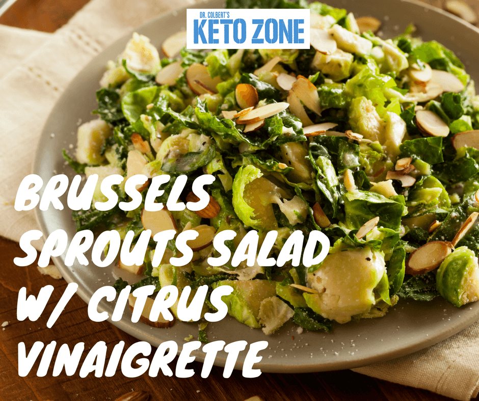 Keto Brussels sprouts and kale salad with slivered almonds and citrus vinaigrette in a bowl