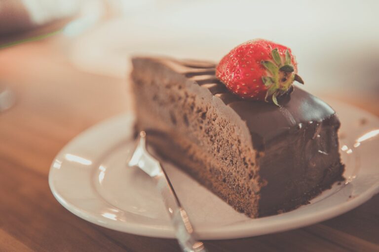 A slice of rich keto chocolate cake on a plate, a sugar free and gluten free low carb dessert