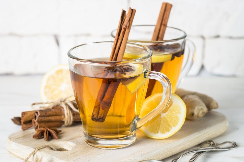 A mug of keto ginger tea with lemon and a cinnamon stick