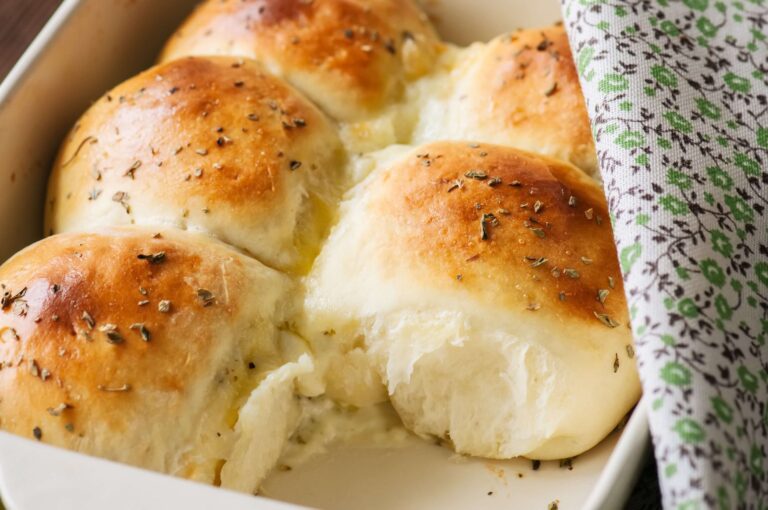 Golden keto mozzarella garlic dinner rolls in a baking pan, a grain free low carb bread