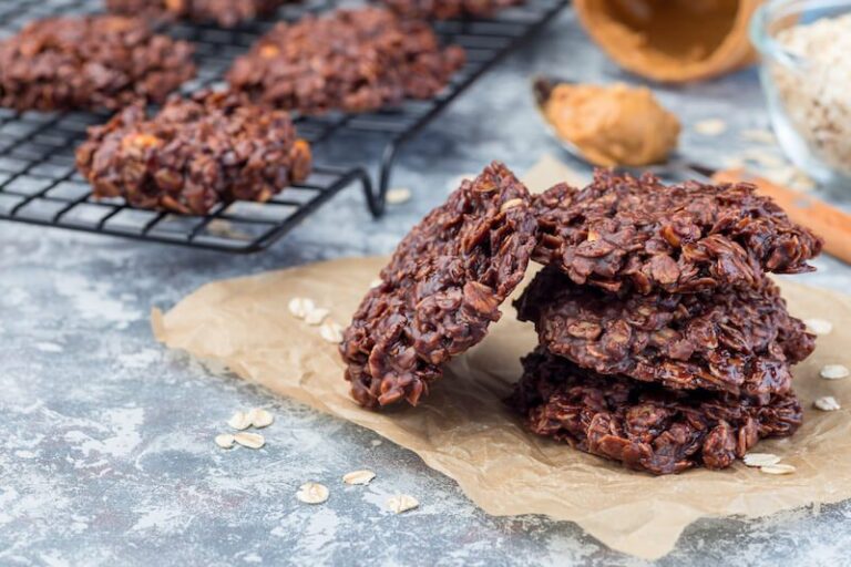 Keto no bake chocolate almond cookies with coconut flakes on parchment paper