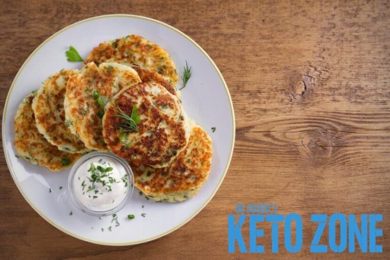Golden keto parmesan zucchini fritters stacked on a plate, a grain free low carb appetizer