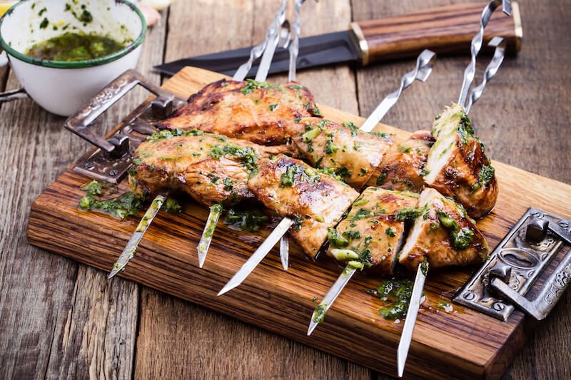 Grilled keto stuffed chicken cutlets with provolone and prosciutto on skewers