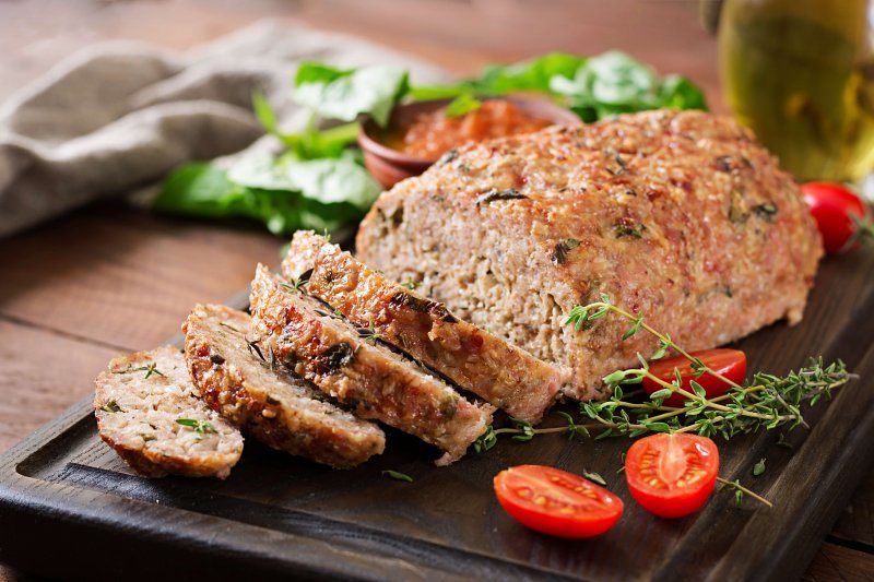 Sliced keto turkey meatloaf on a board, a gluten free low carb dinner bound with psyllium husk